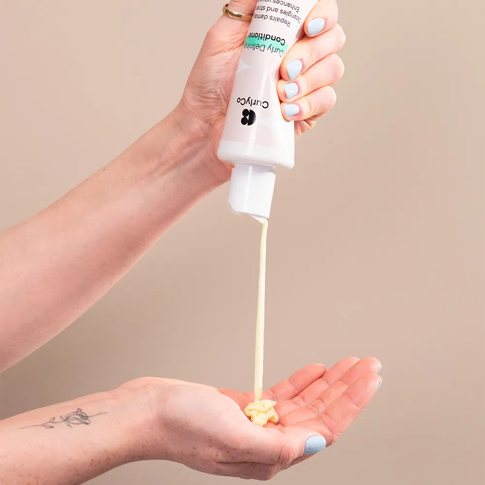 Curly Defining Conditioner being applied to palm