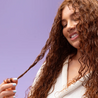 Curly hold gel being used in hair