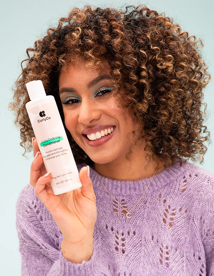 Woman holding Curly Co conditioner