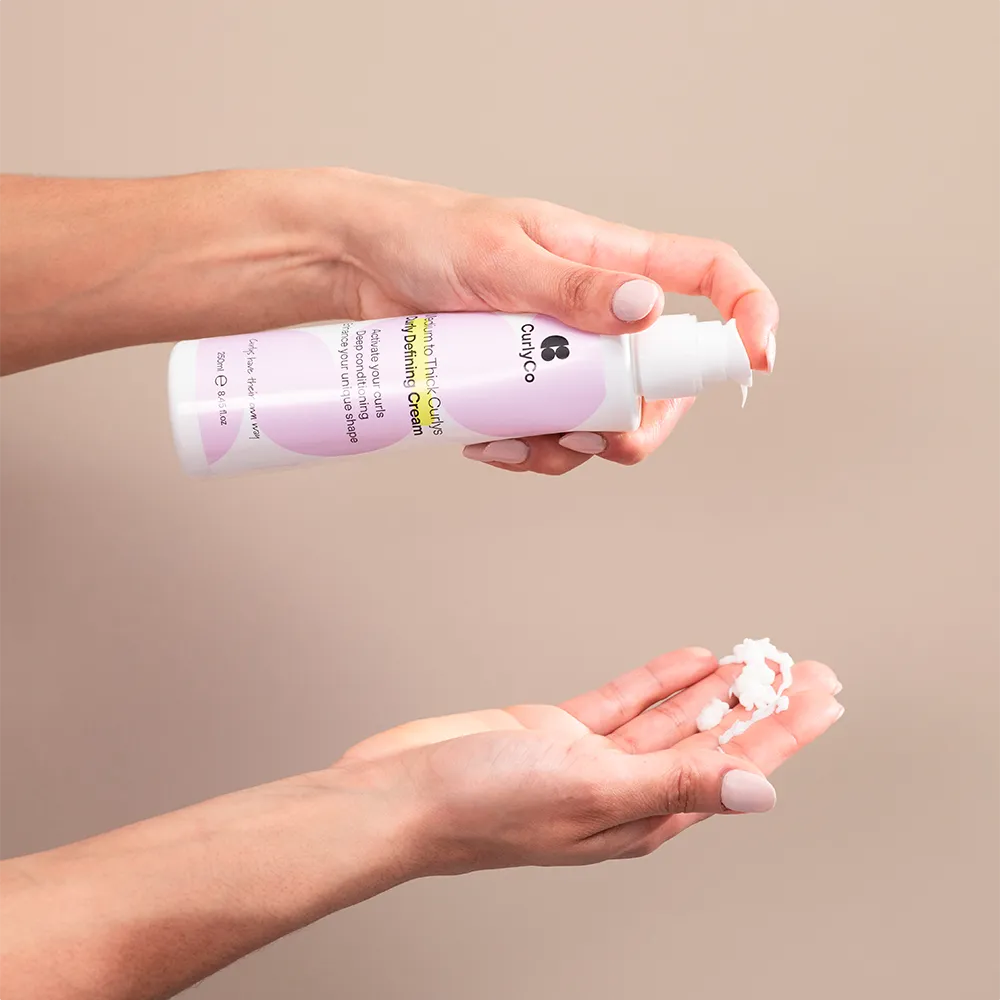 Curly Defining Cream being applied to hand
